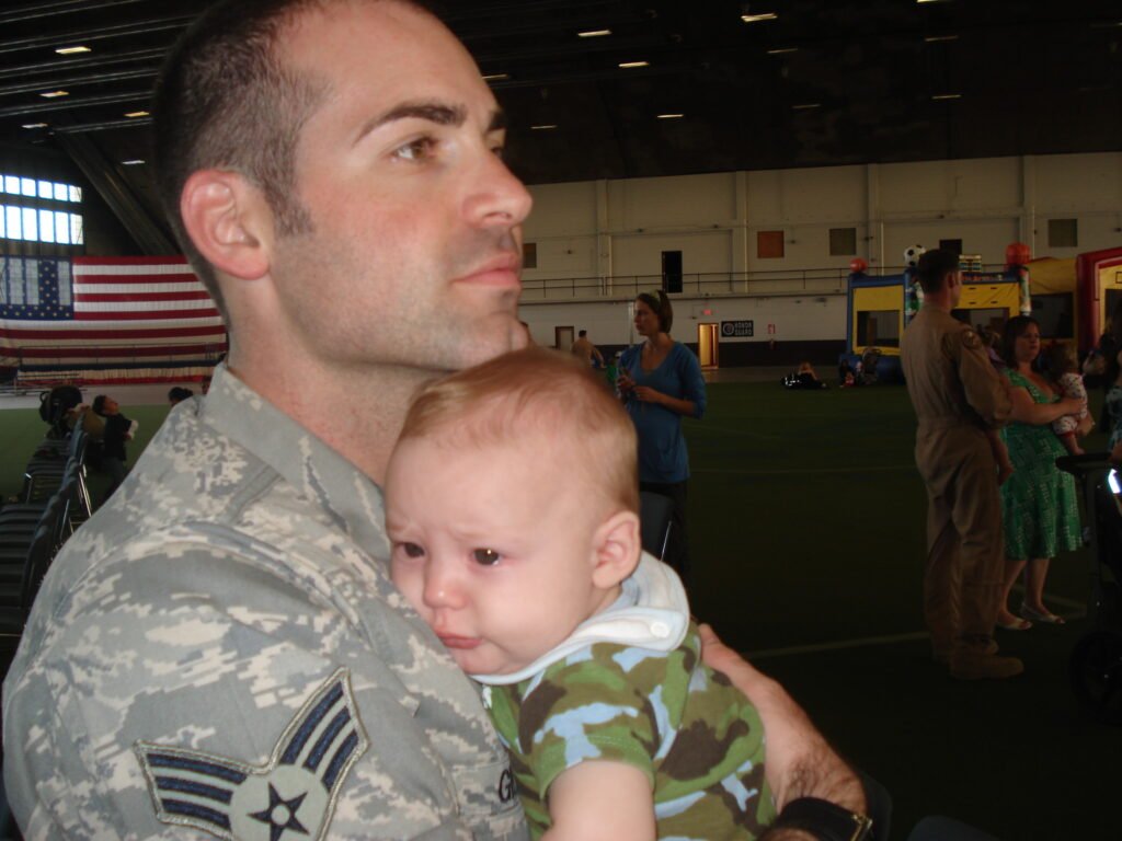Father meeting his baby for the first time in military uniform